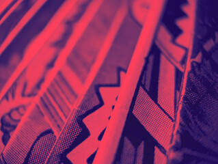 Closeup view of an old comic book collection creates colorful background paper texture with red and blue duotone effect