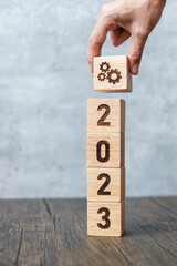 2023 block with gear icon. Business Process, Team, teamwork, Goal, Target, Resolution, strategy,...