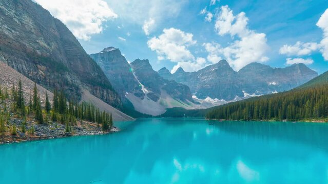 4K time-lapse UHD video of  beautiful view of an iconic famous place, Moraine Lake, a glacier lake located in Banff National Park,Alberta, Canada, in a colorful sunset cloudy summer autumn day. 