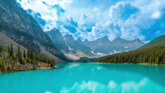 4K time-lapse UHD video of  beautiful view of an iconic famous place, Moraine Lake, a glacier lake located in Banff National Park,Alberta, Canada, in a colorful sunset cloudy summer autumn day. 