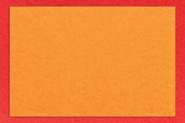 Texture of craft bright orange color paper background with red border, macro. Vintage dense kraft ginger cardboard