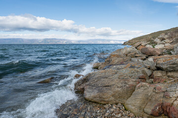 Fototapeta na wymiar Beautiful summer landscape of Baikal Lake on sunny day. View of the rocky cape