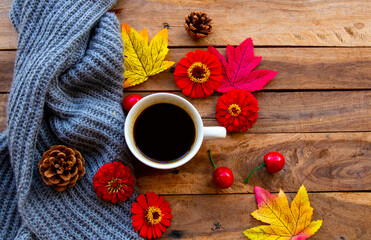 hot coffee espresso, knitting wool scarf with mable leaf in autumn season arrangement flat lay postcard style on background wooden