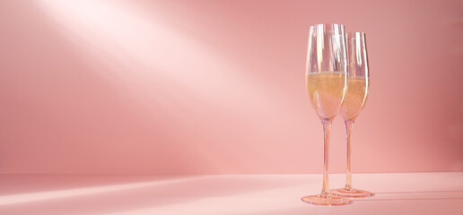 Glasses of champagne in pink studio