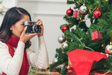 Woman Photographer take photo christmas decorate bauble ball xmas tree on holiday winter season...