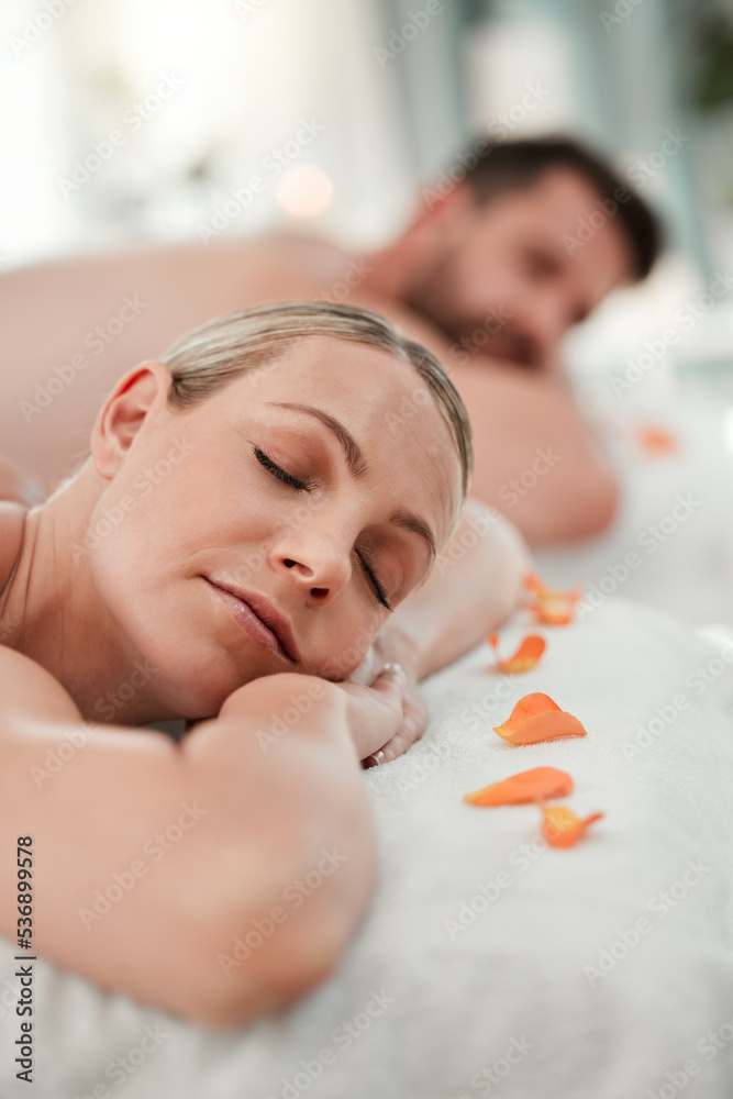 Wall mural Relax, spa and couple in luxury massage for health, wellness and therapy treatment at a resort indoors. Man and woman resting head on massaging table to enjoy a calm day of zen, care and relaxation