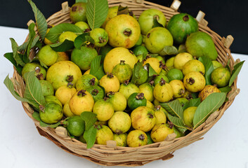 Many whole ripe guava fruits harvest in basket in vietnam