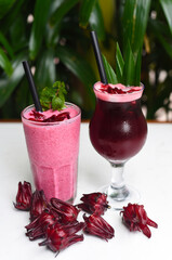 Hibiscus smoothie and ice tea on a white tableclose up   © Tatiana