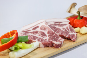 Grilled beef steak and vegetables isolated against a white background