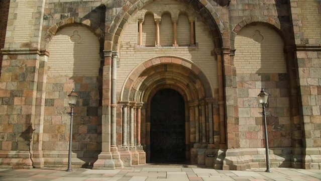 Entrance of Ribe Cathedral Church in Denmarks oldest City against blue Sky. 4K.