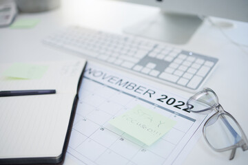 Fototapeta premium Calendar, schedule and management of a working business person planning goals and priorities at a table. Time, event and list for worker plan agenda and strategy for effective multitasking reminder