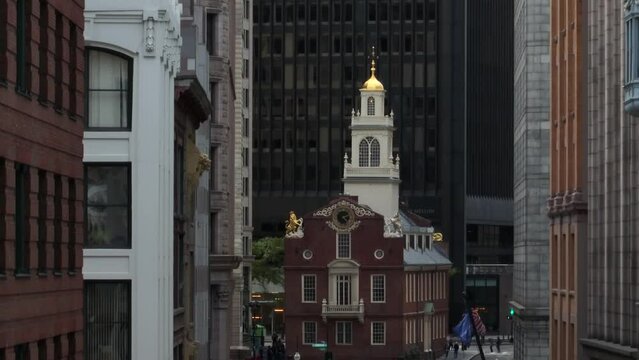 Unique long zoom lens. Rising aerial of Faneuil Hall set among skyscrapers.