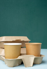 Eco friendly,take away disposable cup kraft paper and tray on green background.food packaging