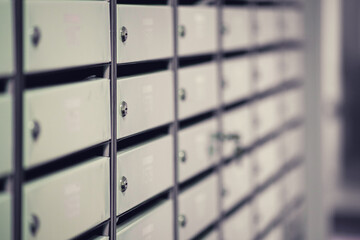 Rows of mailboxes in the lobby of an apartment building, A lot of mailboxes with apartment numbers