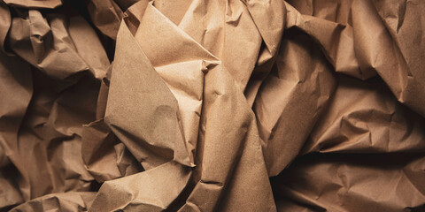folded brown wrapping paper for packaging or handicraft work with abstract folds and creases and...