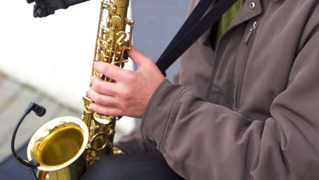  Man playing the saxophone, close-up on the fingers
