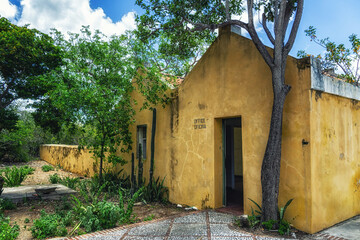 Old derelict house with trees and garden on island Bonaire