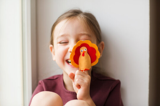 craft for kids. DIY felt Turkey for thanksgiving day. create art for children. girl playing with finger toy
