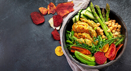 Vegan buddha bowl. Bowl with  vegetables, Zucchini fritters and vegetables chips.