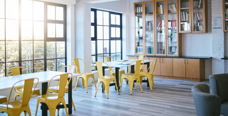 Education, library and learning space interior for college or university workspace table by window with lens flare. Architecture, furniture and study room design for scholarship community background