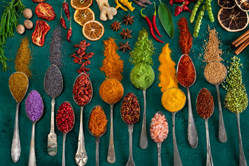 Many various multi colored spices and dried fruits on the table