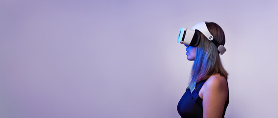 Woman is using virtual reality headset. Concept of virtual, augmented and extended reality and metaverse.
