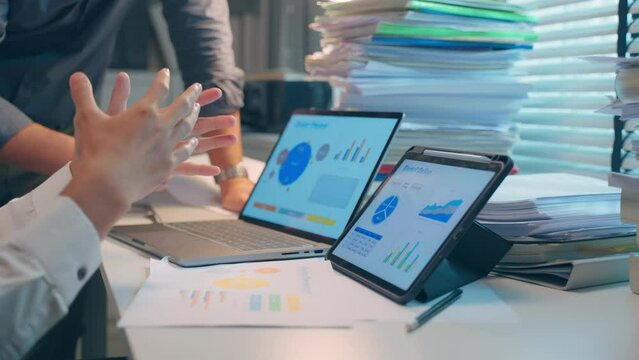 Close up of Asian two businessman using tablet computer work in office