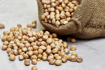 chickpeas in a canvas bag and scattered on the table