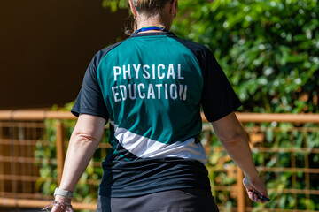 Fototapeta premium Back view of swimming coaches, wearing COACH shirt