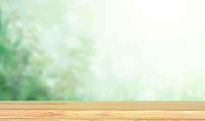 Old wooden table and abstract green background. Empty wooden table top on blurred backdrop. Rustic...