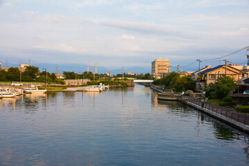 Fototapeta premium Scenery of Iwase canal and Toyama townscape at sunset.