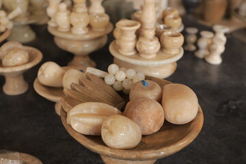 Variety of traditional handcrafted ceramics on shelves of souvenir shop 
