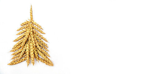 Creative Christmas tree made of wheat ears on a white background.Christmas and New Year flat lay.Copy space for text. - obrazy, fototapety, plakaty