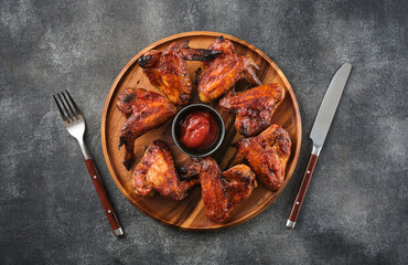 Grilled chicken wings with ketchup. Spicy chicken wings