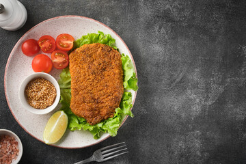 Pork cutlet with vegetables, top view.
