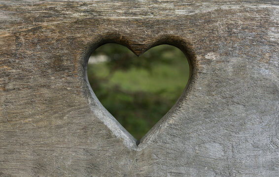 Heart shape carved on wooden plank
