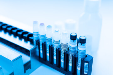 Reagent tubes and bottes for laboratory analysis automate machine.Sample specimen in test tube and chemistry and immunology reagent bottle .Conceptual image COVID-19 test tube sample.