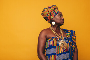 Stylish African woman wearing a cultural attire in a studio