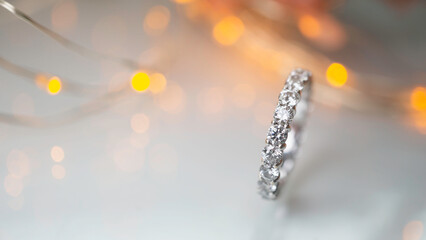 Close up of diamond ring with blurry bokeh background. Love, valentine, relationship and wedding...