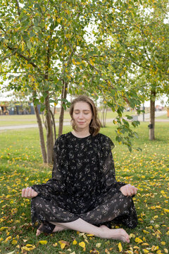 Young woman mediating in park