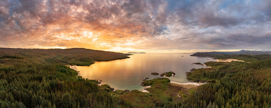 Aerial view of Singing sands and Cul na Croise beach with Eigg and Rum at sunset, Scotland