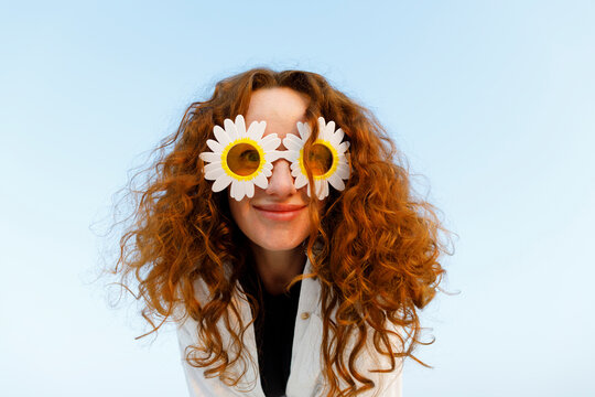 Smiling Woman With Curly Hair Wearing Sunflower Sunglasses