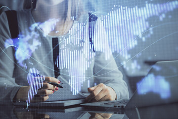 Multi exposure of woman hands typing on computer and business theme hologram drawing. Success concept.
