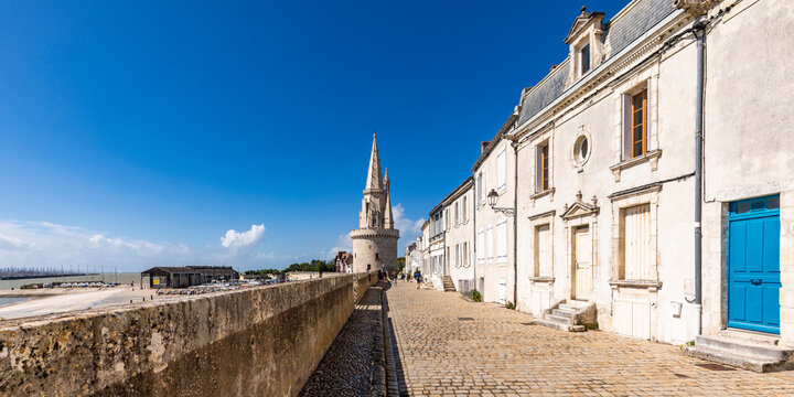 France, Nouvelle-Aquitaine, La Rochelle, Paved footpath with Lantern Tower in background