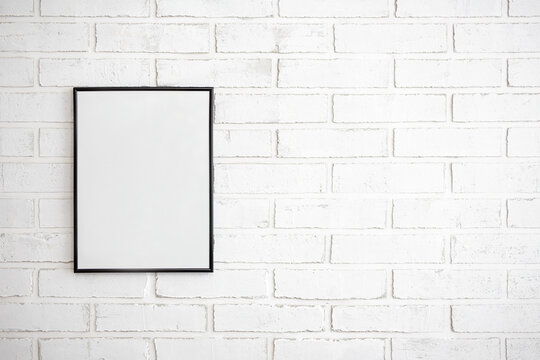 photo or picture frame over white brick wall background
