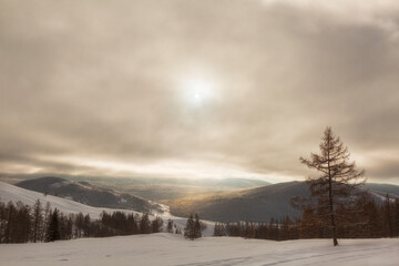 Beautiful winter sunrise landscape with mountains. Altai. Russia