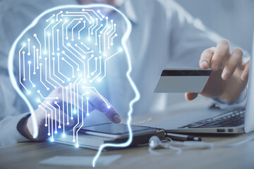Double exposure of man hands typing on computer with credit card and brain theme drawing. E-commerce and AI concept.