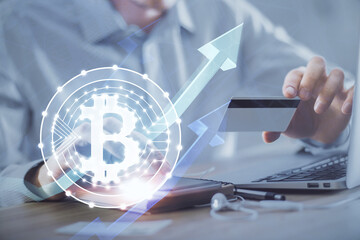 Double exposure of man hands holding a credit card and crypto business theme drawing. Digital blockchain and E-commerce concept.