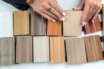hands hold a wooden color guidebook.