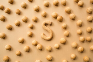 pepernoten or kruidnoten: sweet traditional dutch cookies for sinterklaas holiday - saint nicholas day. beige neutral holiday background